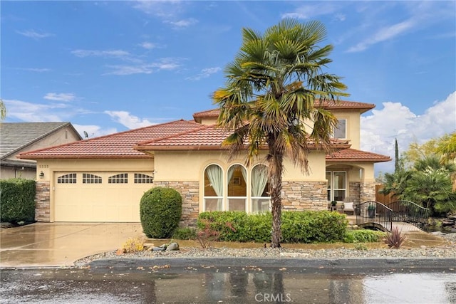 mediterranean / spanish-style home featuring a garage