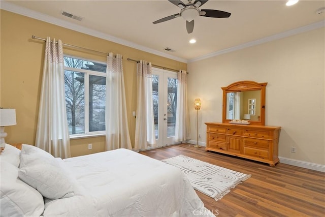 bedroom with ceiling fan, multiple windows, access to outside, and hardwood / wood-style floors