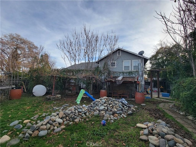 rear view of house with an outdoor fire pit