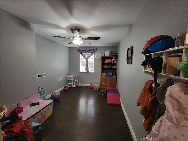 recreation room with dark hardwood / wood-style floors and ceiling fan