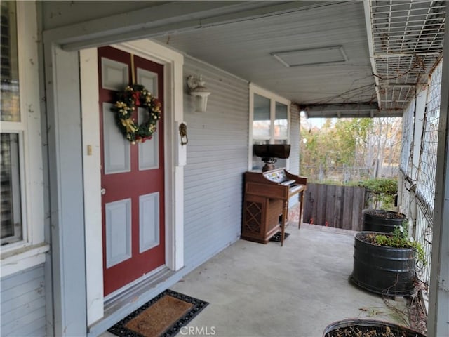 view of exterior entry with a porch