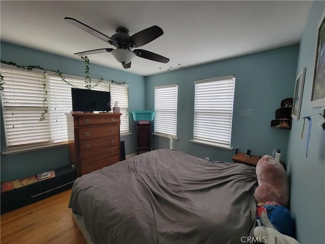 bedroom featuring hardwood / wood-style floors and ceiling fan