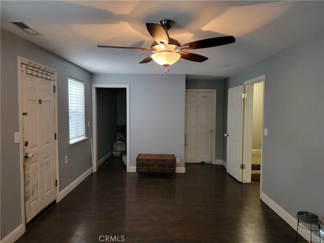 foyer with dark hardwood / wood-style floors and ceiling fan