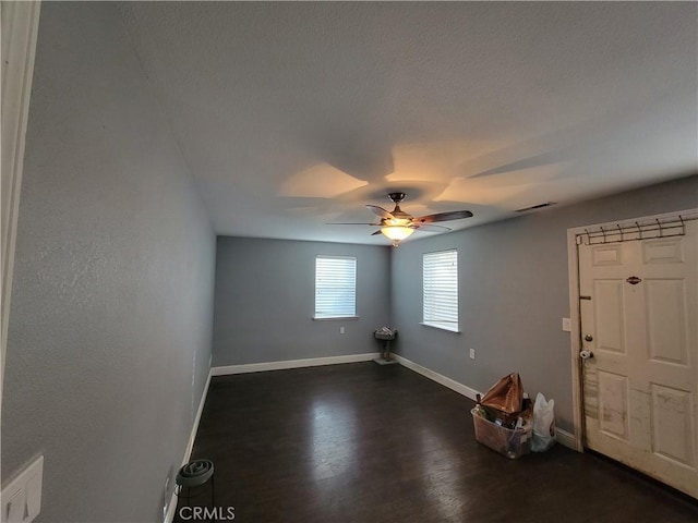 spare room featuring dark hardwood / wood-style floors and ceiling fan