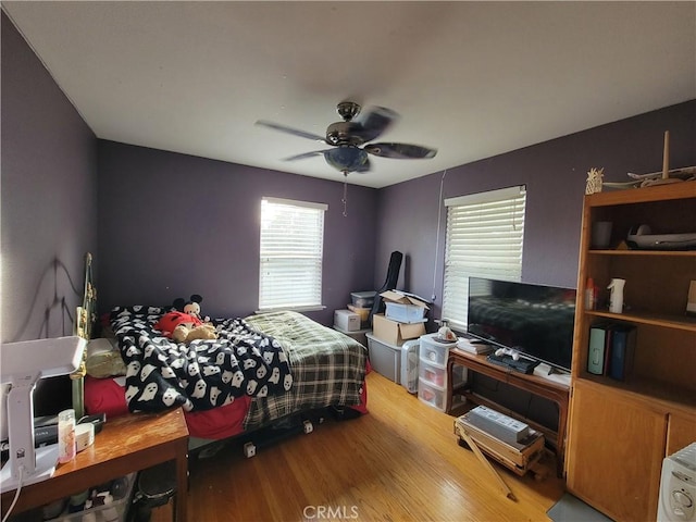 bedroom with hardwood / wood-style flooring and ceiling fan