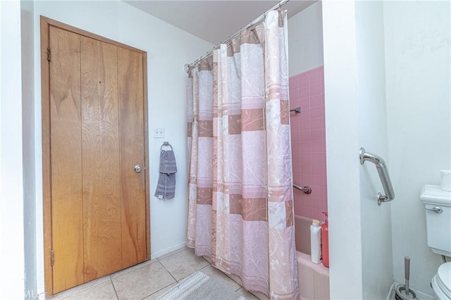 bathroom featuring tile patterned floors, shower / bath combination with curtain, and toilet