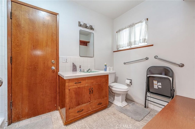 bathroom featuring backsplash, vanity, and toilet