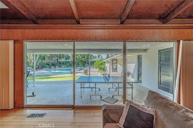 sunroom / solarium featuring beam ceiling and a wealth of natural light