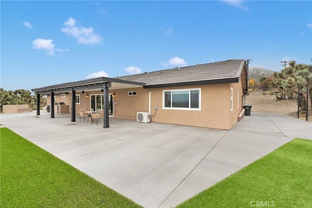 back of property featuring ceiling fan, a patio area, a lawn, and ac unit