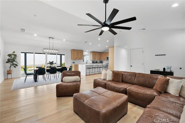 living room featuring ceiling fan and light hardwood / wood-style floors