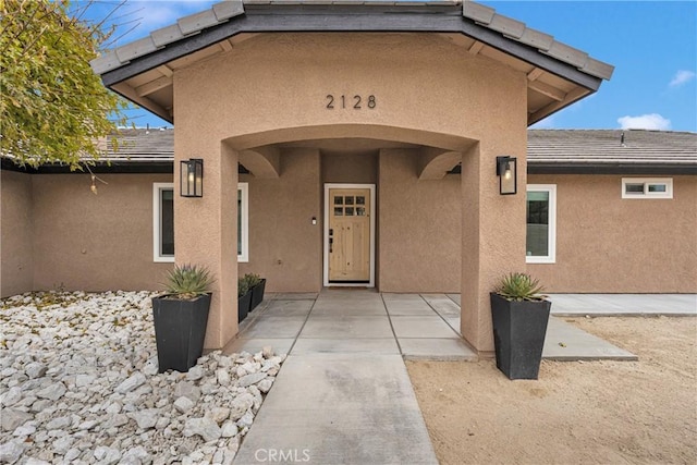 entrance to property with a patio