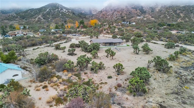 birds eye view of property with a mountain view