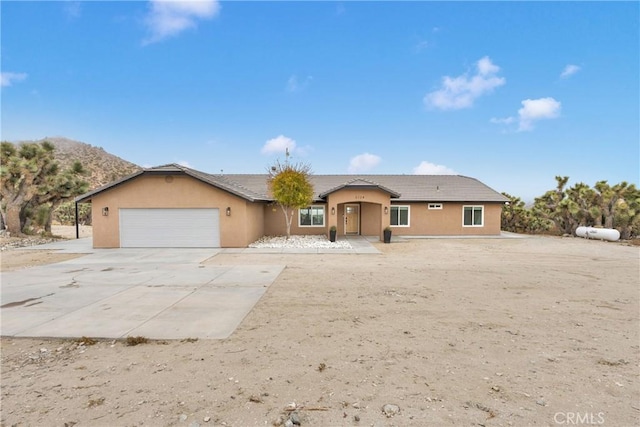 view of front of property with a garage and a mountain view