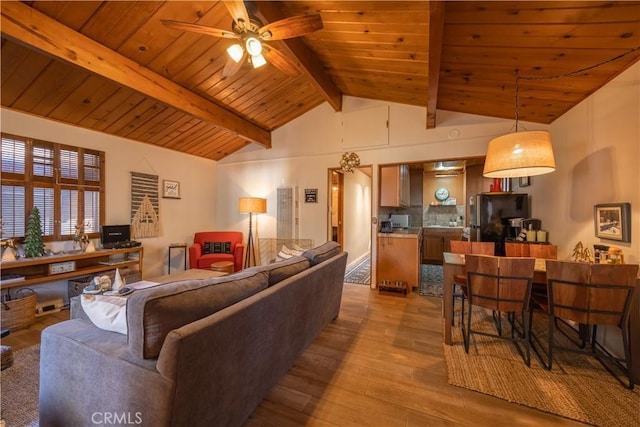 living room with vaulted ceiling with beams, light hardwood / wood-style floors, ceiling fan, and wooden ceiling