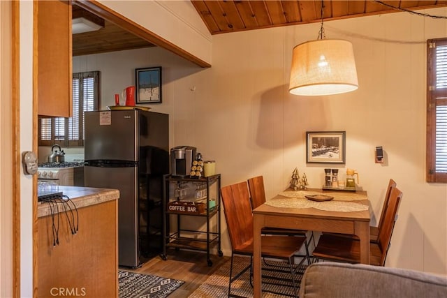 dining area featuring wooden ceiling, lofted ceiling, and hardwood / wood-style flooring