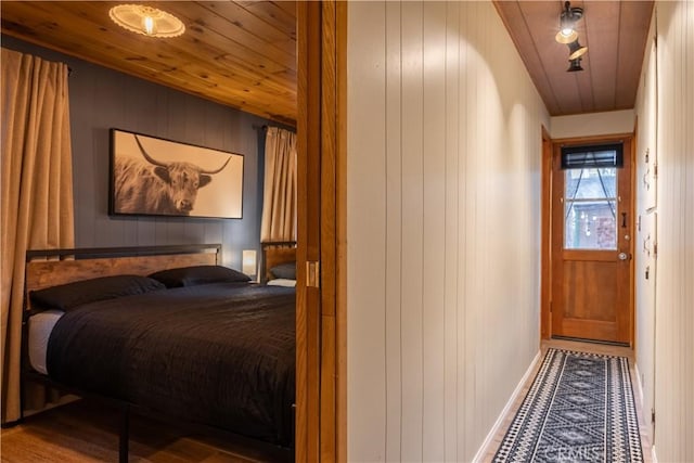 interior space featuring hardwood / wood-style flooring, wood walls, and wood ceiling