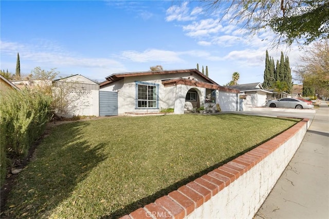 view of front of home with a front lawn and a garage