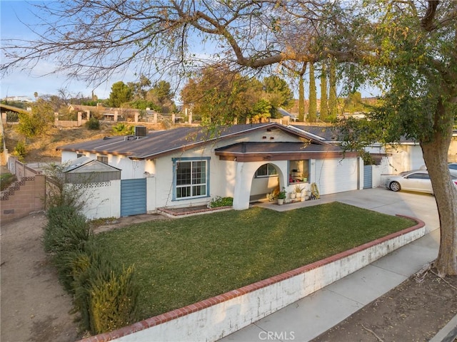 view of front facade with a garage and a front lawn