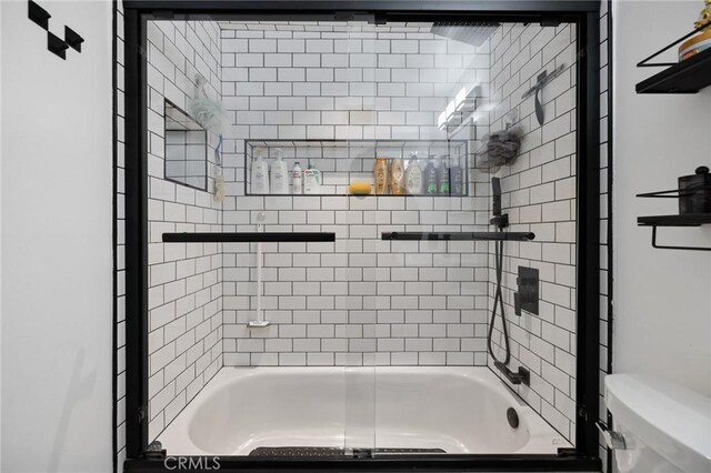 bathroom featuring toilet and enclosed tub / shower combo