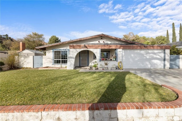 view of front of house with a front yard and a garage