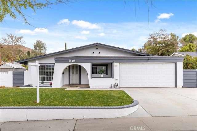 single story home featuring a garage and a front lawn