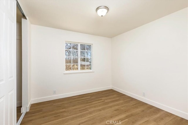 unfurnished room with hardwood / wood-style floors