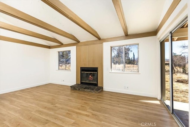 unfurnished living room featuring hardwood / wood-style floors and lofted ceiling with beams