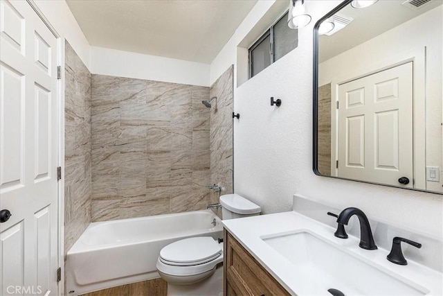 full bathroom with toilet, vanity, wood-type flooring, and tiled shower / bath