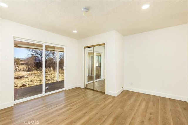 unfurnished room with light hardwood / wood-style flooring