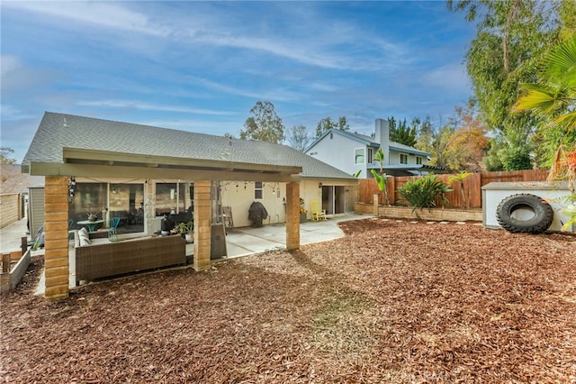 back of house with a patio