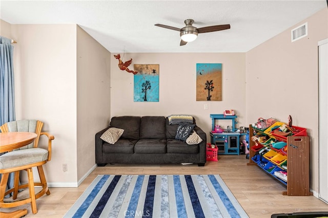 rec room with ceiling fan and light hardwood / wood-style floors