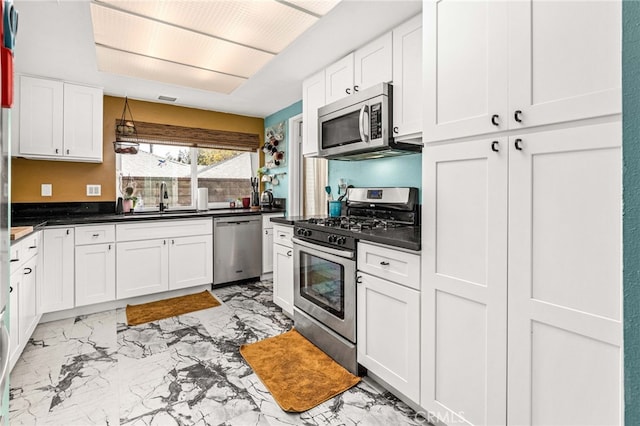 kitchen featuring sink, white cabinetry, and stainless steel appliances