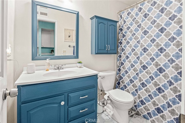 bathroom featuring toilet and vanity