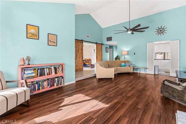 living room featuring high vaulted ceiling, a barn door, ceiling fan, and hardwood / wood-style flooring