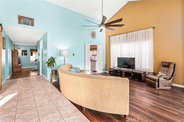 living room with ceiling fan and high vaulted ceiling