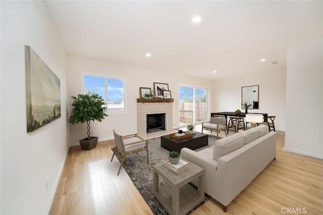 living room with a fireplace and light hardwood / wood-style flooring