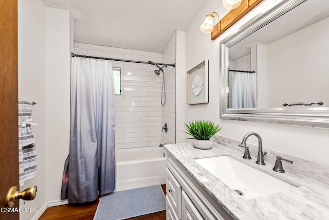 bathroom with hardwood / wood-style floors, vanity, and shower / bath combo with shower curtain