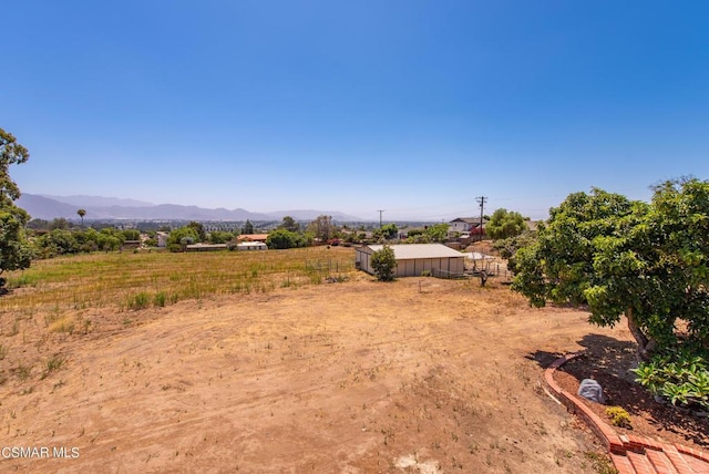 view of yard with a mountain view and a rural view