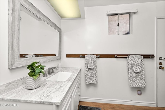 bathroom featuring hardwood / wood-style flooring and vanity