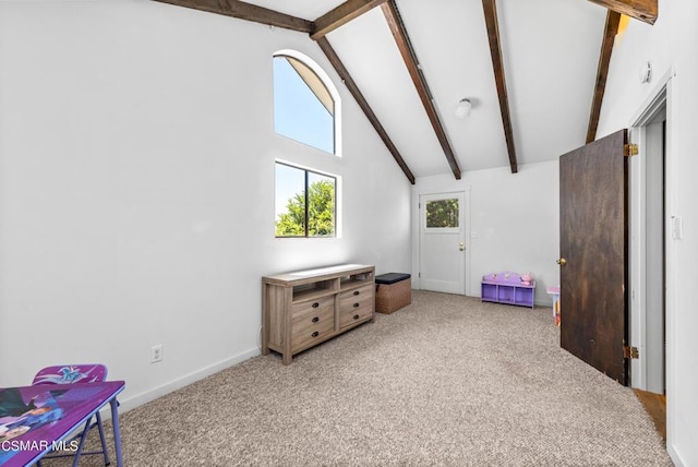 interior space with beam ceiling, carpet floors, and high vaulted ceiling