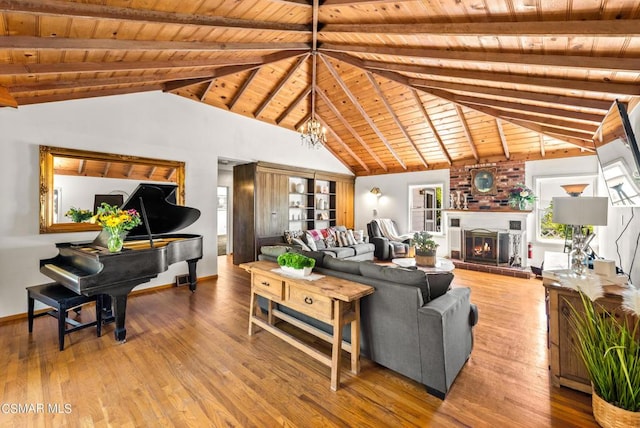 living room featuring hardwood / wood-style floors, vaulted ceiling with beams, wood ceiling, and a brick fireplace