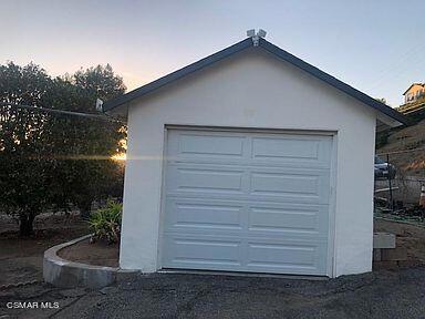 view of garage at dusk