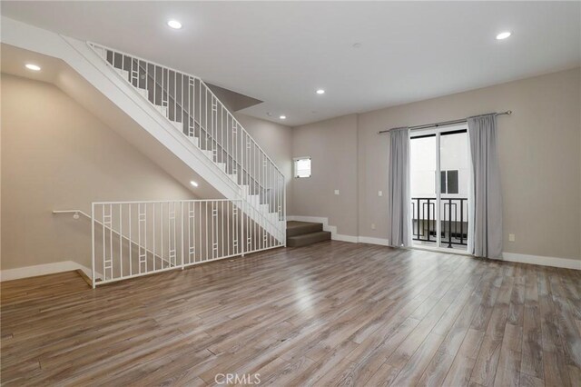 unfurnished living room with hardwood / wood-style flooring