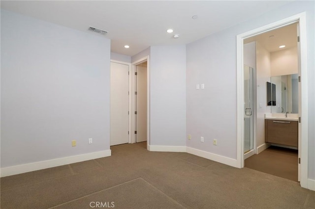 carpeted empty room featuring sink