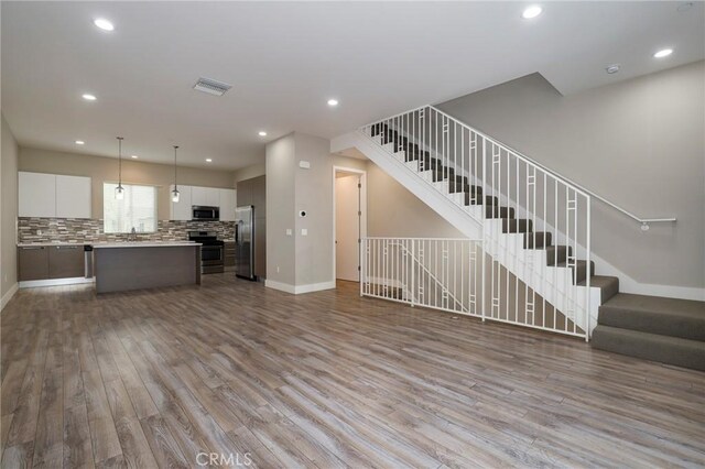 unfurnished living room featuring light hardwood / wood-style flooring