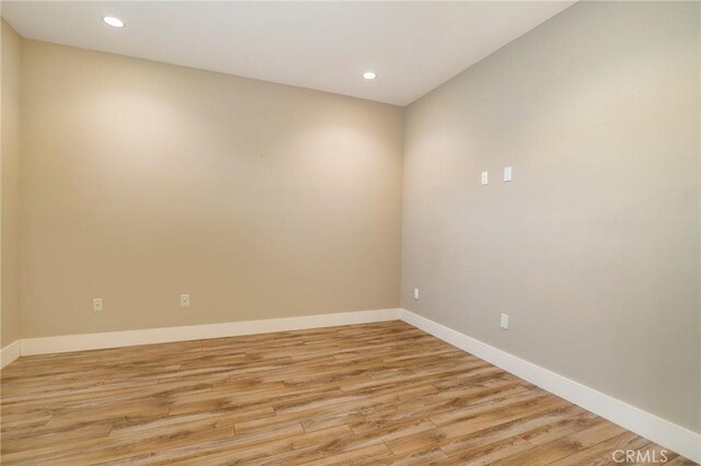 empty room with light hardwood / wood-style floors