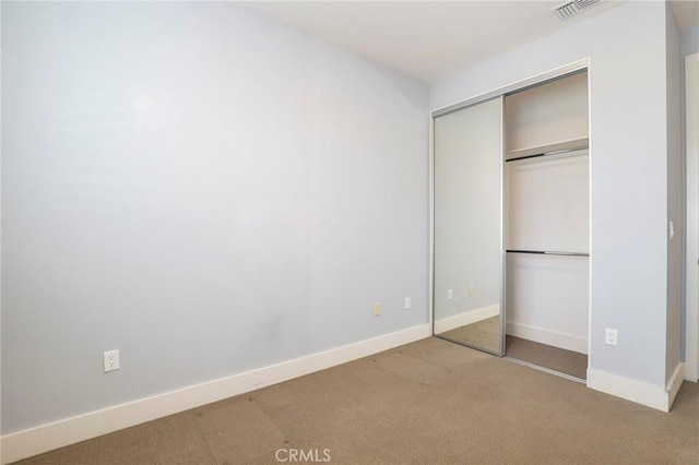 unfurnished bedroom featuring light carpet