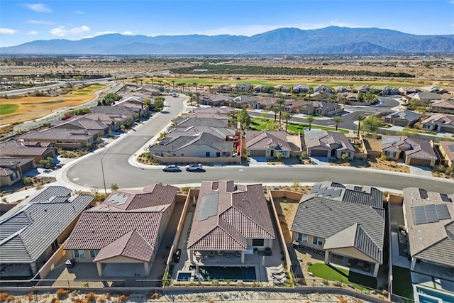 birds eye view of property with a mountain view