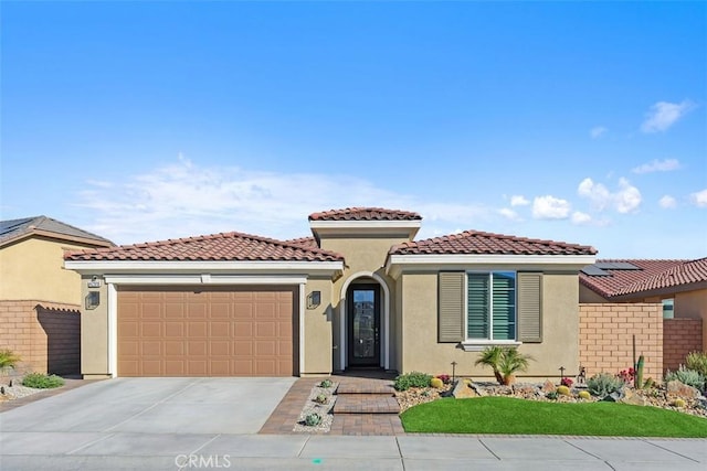 mediterranean / spanish-style home featuring a garage