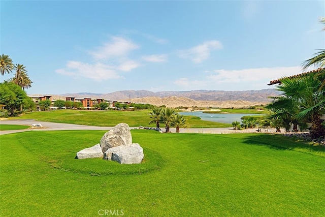 surrounding community featuring a yard and a water and mountain view